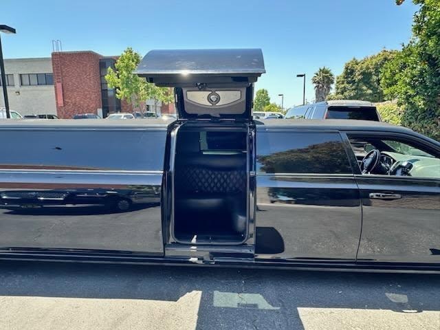 Chrysler 300 stretch limo — open door showing diamond-stitch entry and bar area