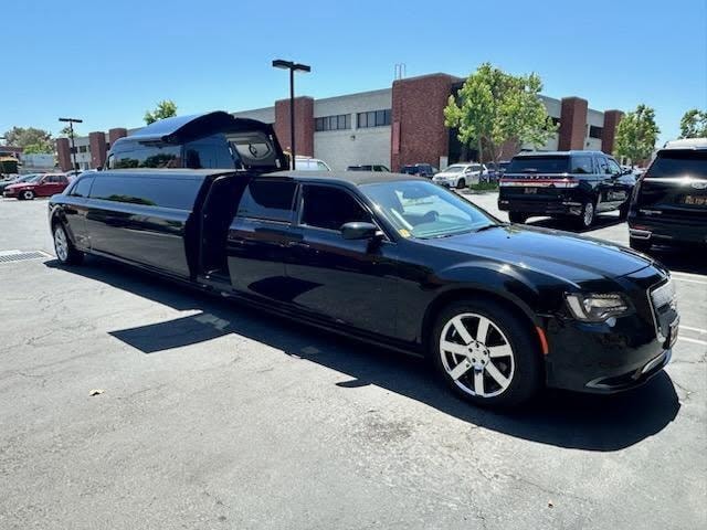 Chrysler 300 stretch limo — full exterior with doors open in parking lot