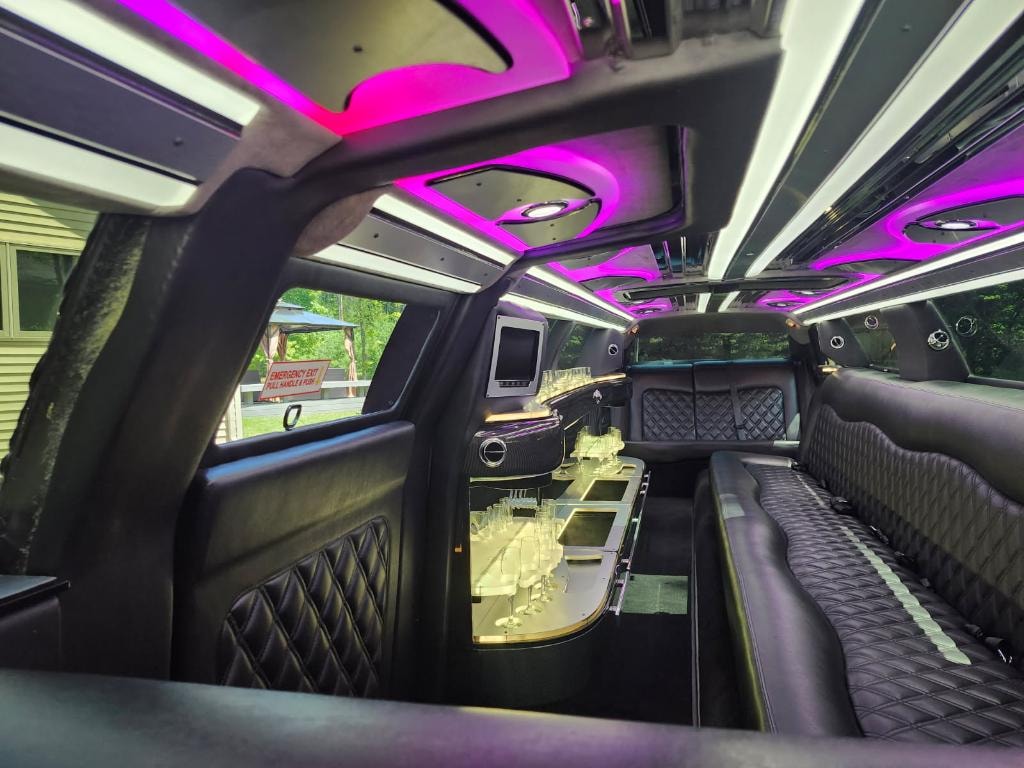 Chrysler 300 interior — pink/purple ambient ceiling lighting with diamond-stitch seating and champagne bar