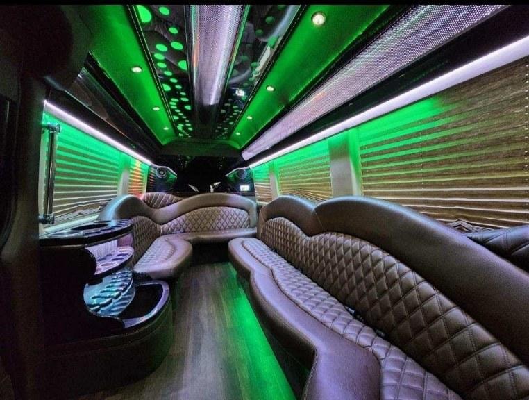 Sprinter van interior — green ambient lighting with diamond-stitch seating
