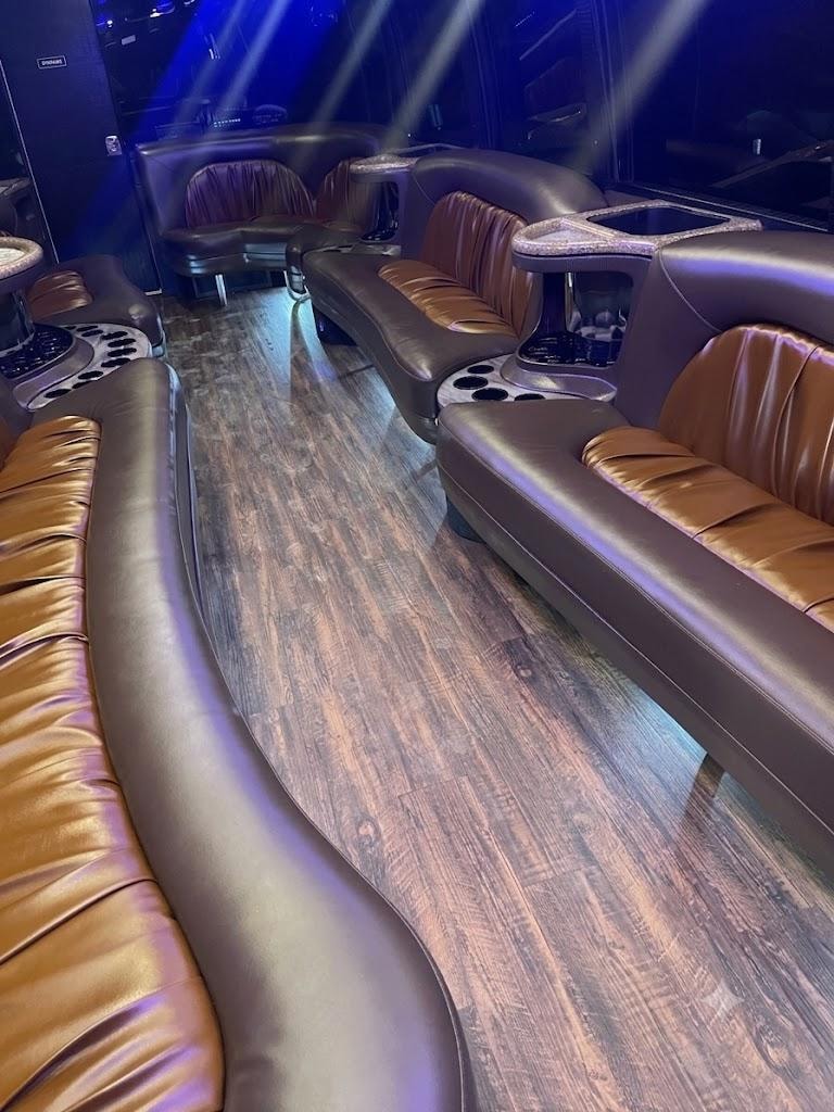 Vegas Limo Bus interior — tan and dark leather seating with hardwood floor and blue ambient lighting