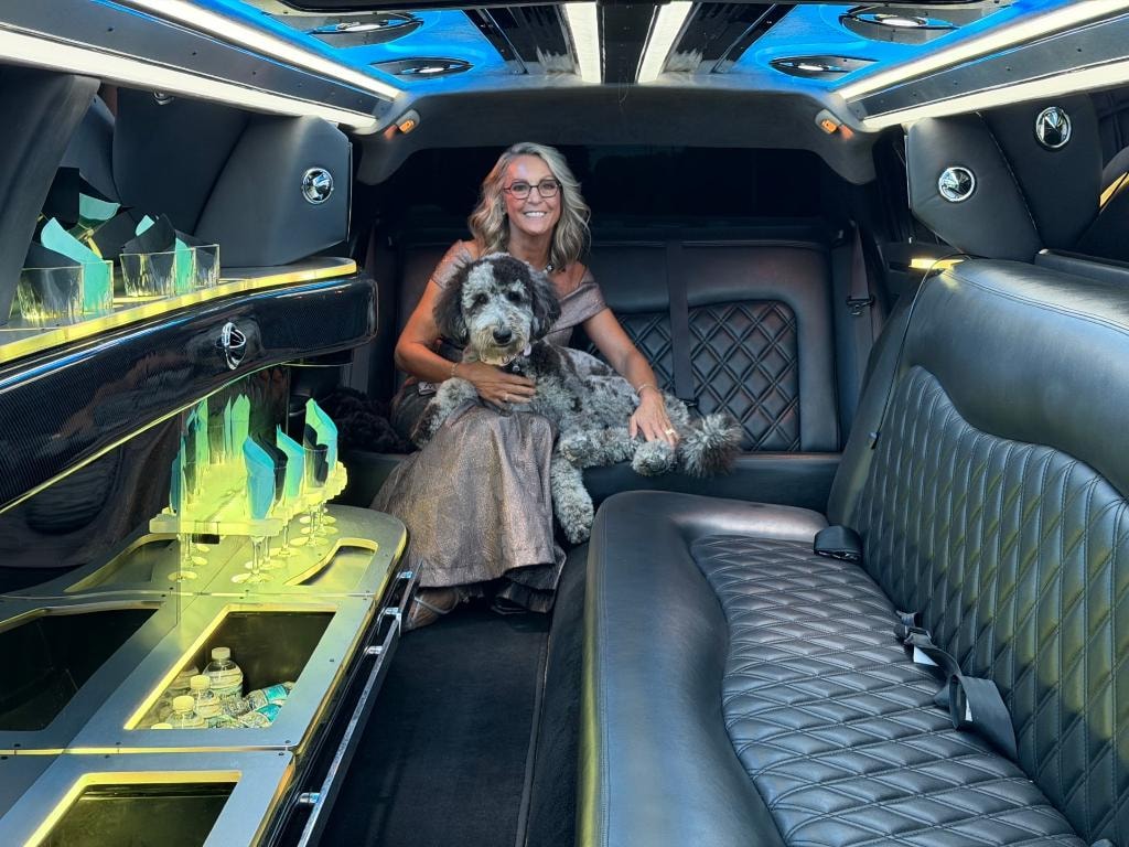 Woman with dog enjoying the luxury limo interior