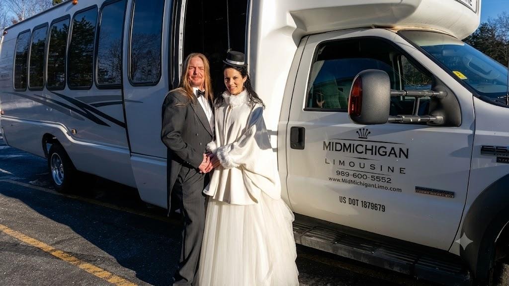 Wedding couple posing beside Mid Michigan Limousine party bus